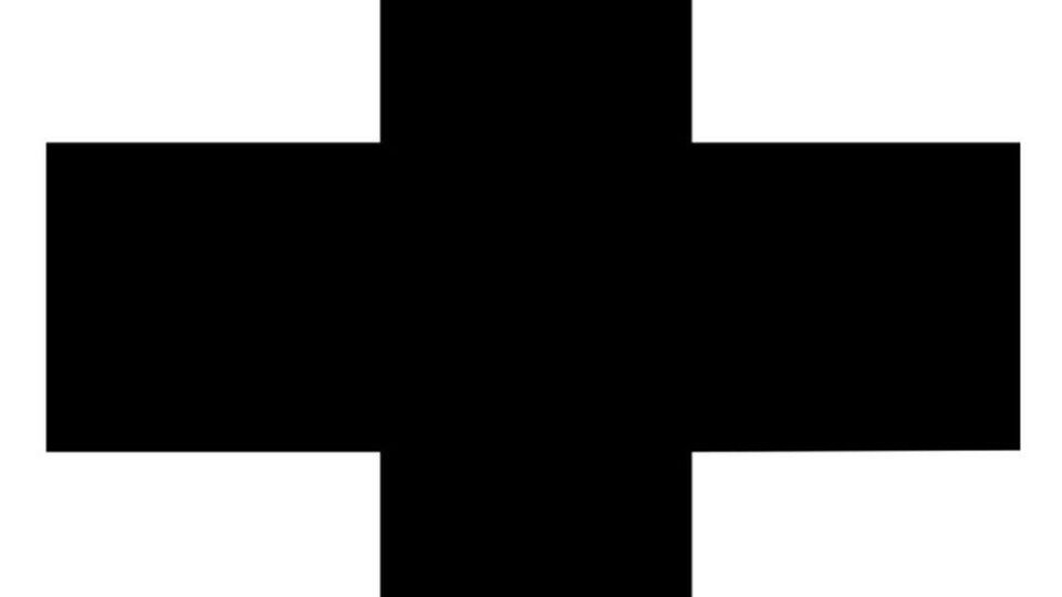 A black cross on a gray background. The symbol is simple and clear.