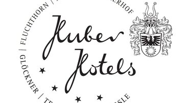 A stylish logo of the Juber Hotels with an elegant script. Surrounded by a decorative circle and the coat of arms at the top center.